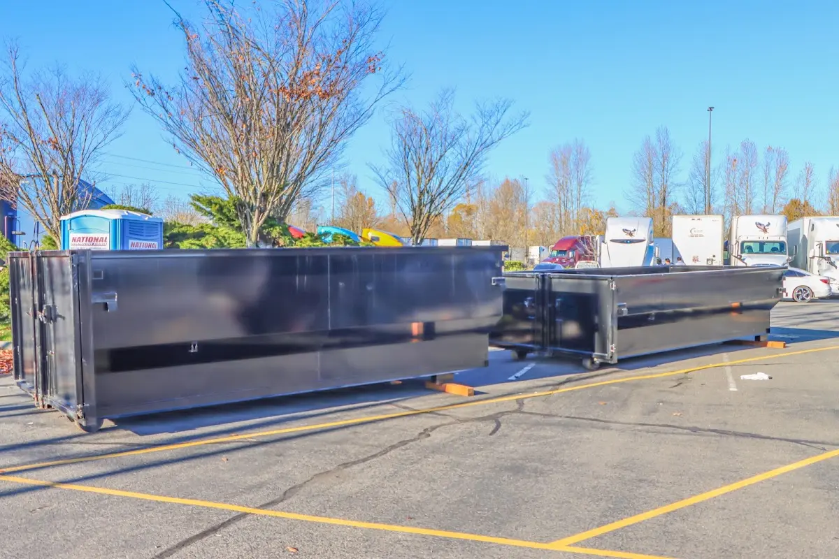 Professional dumpster rental service with roll-off container on residential driveway in Hesperia